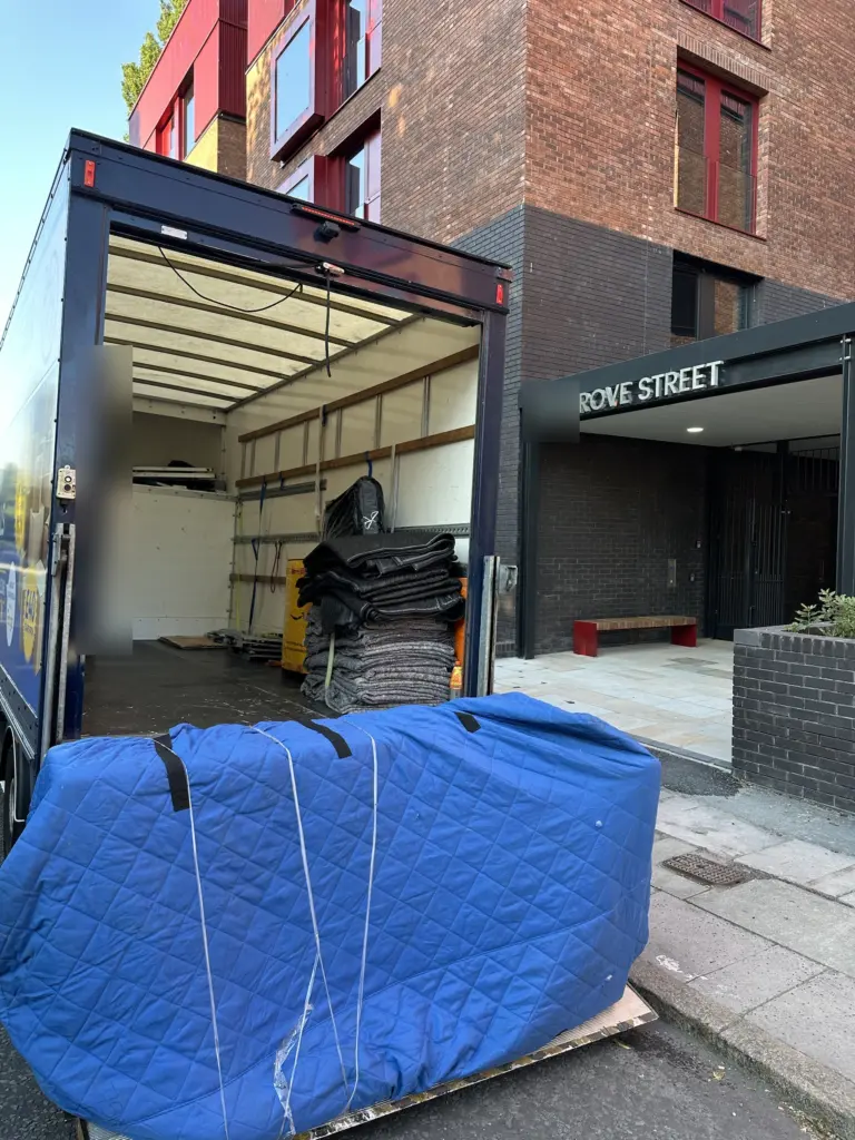Removal van unloading at a new build block of flats on Grove Street, Liverpool