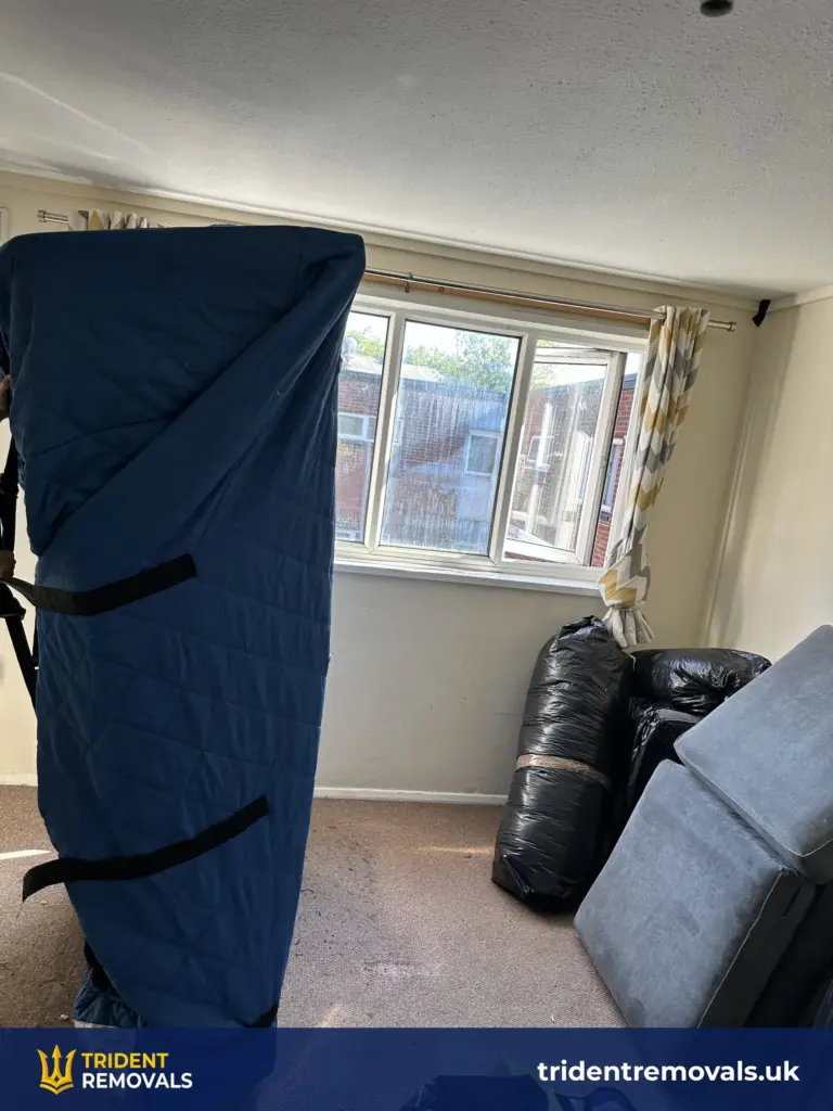 Sofa wrapped in a protective cover before a flat removal in Grovelands, Liverpool