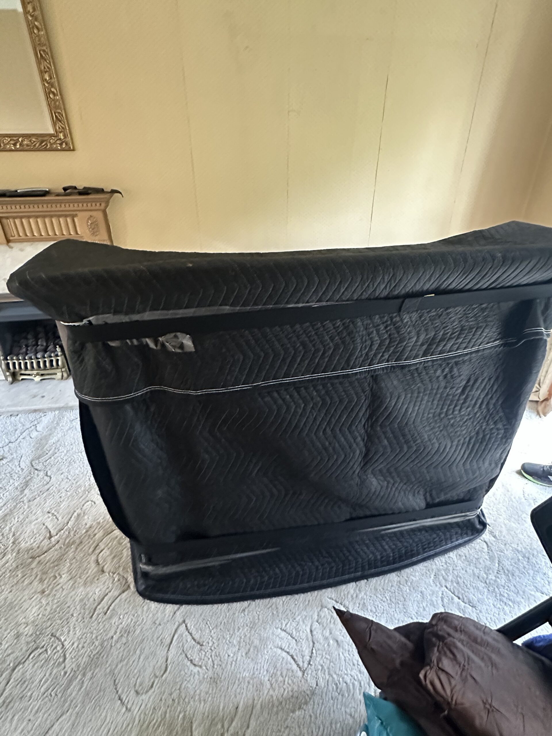 Quilted furniture protection cover used to safeguard items during transport