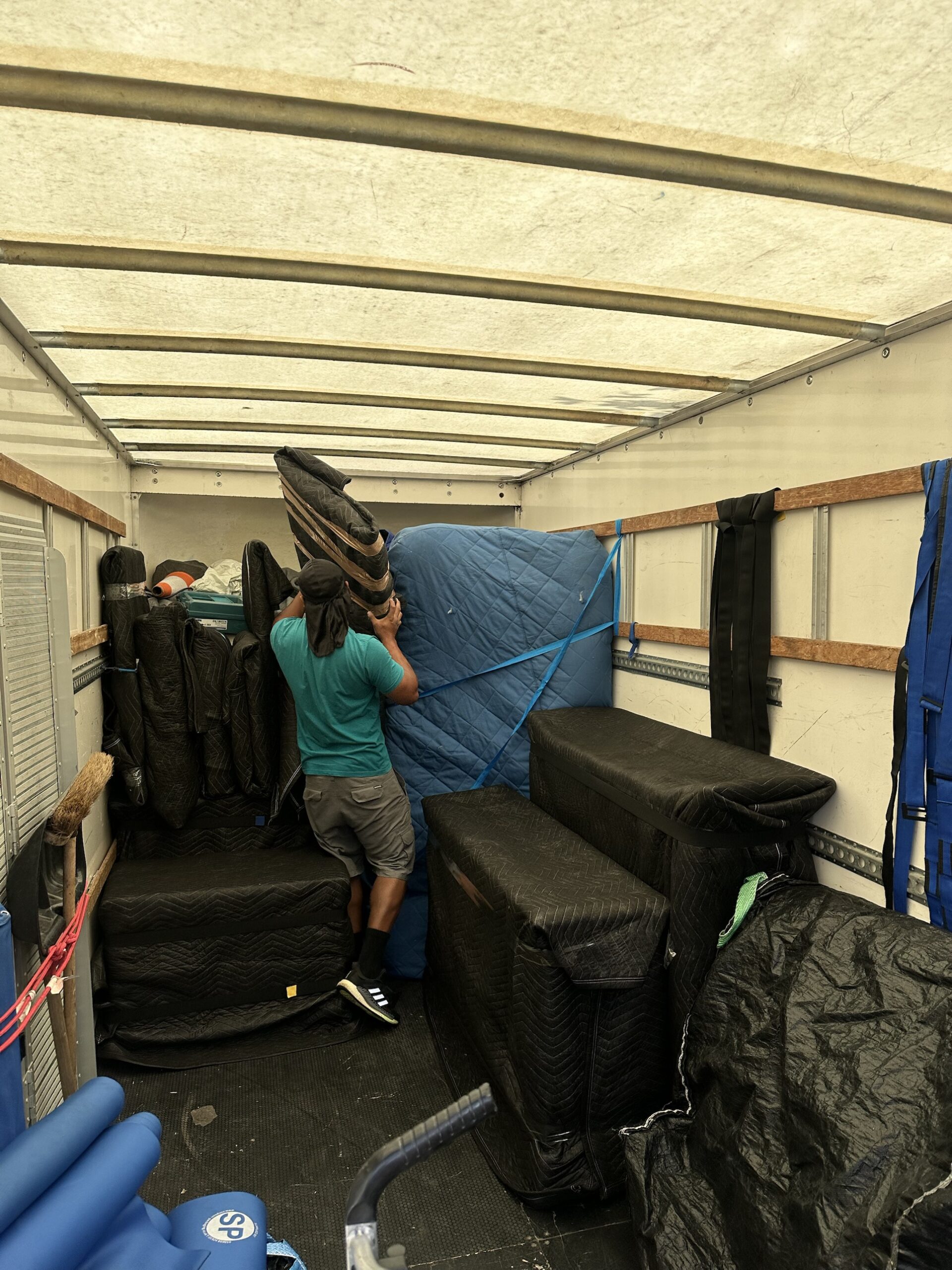 Trident Removals team loading padded and wrapped furniture into the removal van