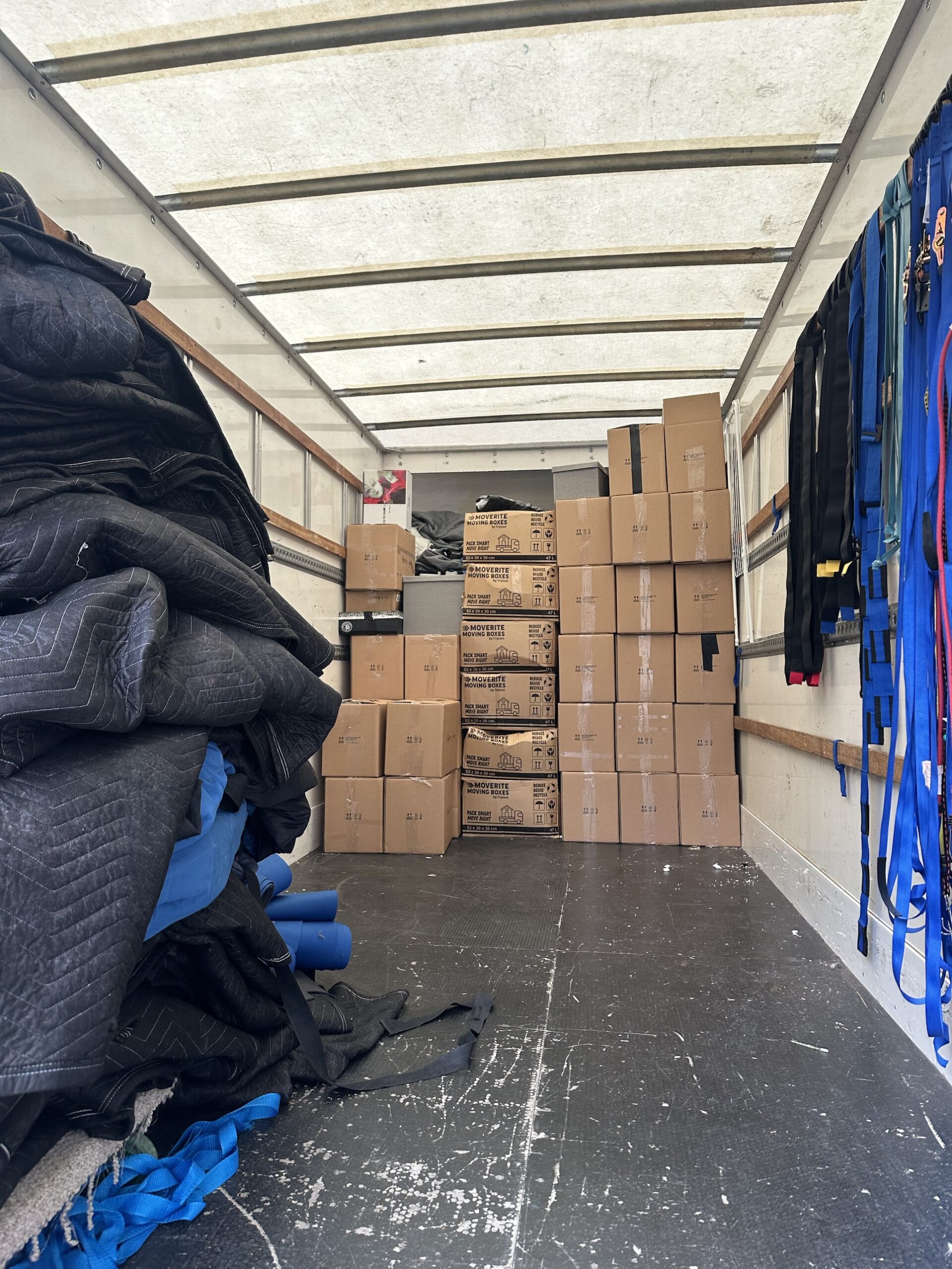 Moving boxes stacked securely in the removal van with blankets and straps for a Toxteth flat move