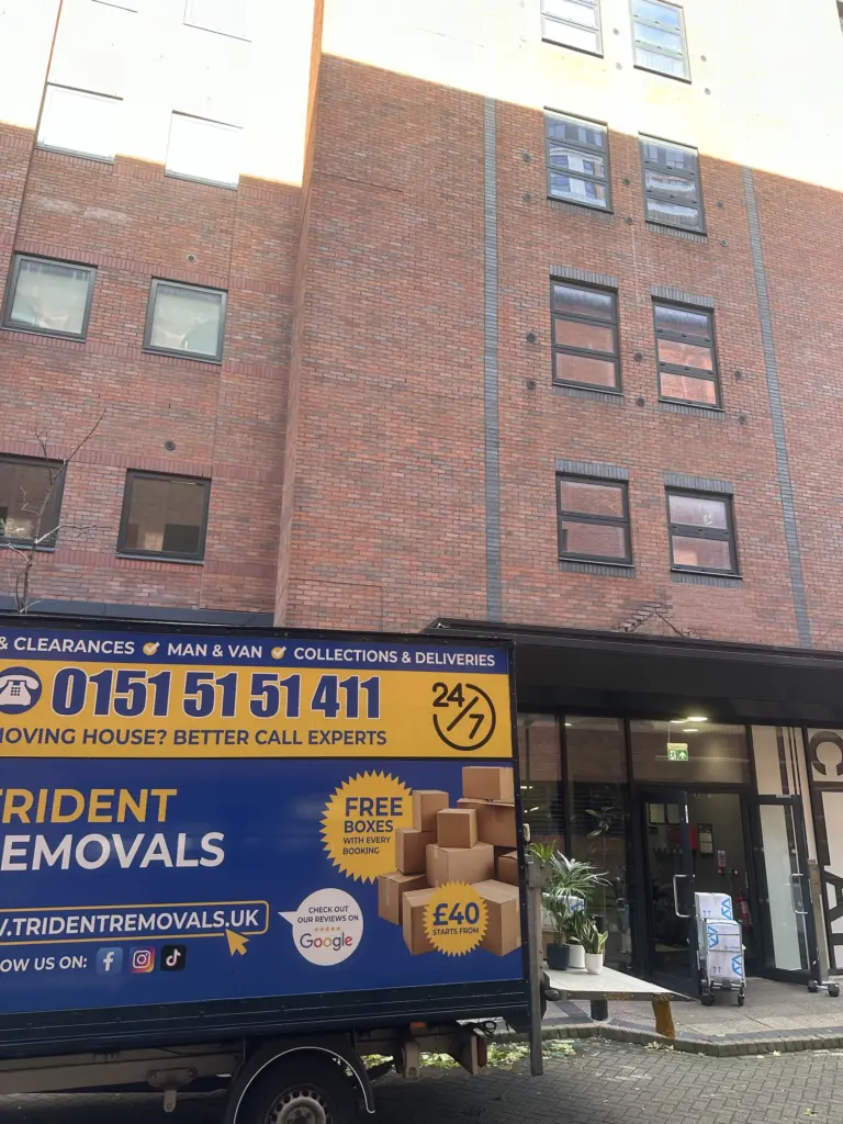 Removal van unloading outside a block of flats in Salford Quays
