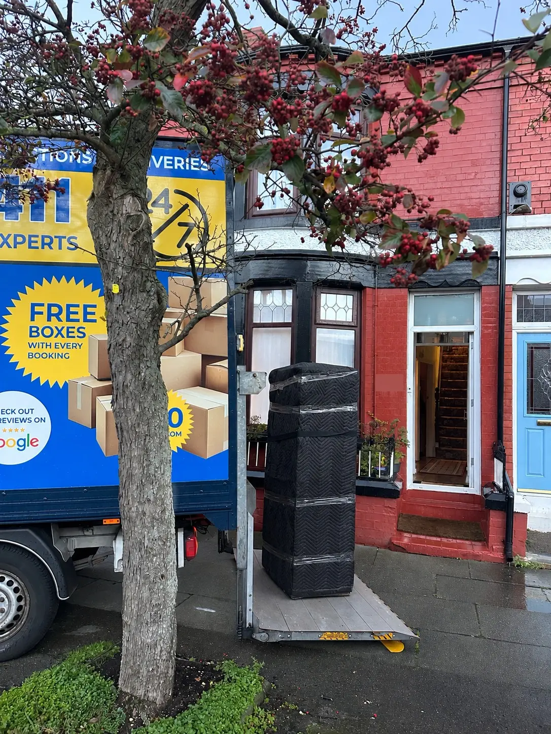 House Removal Bromborough to Wavertree: Cast Iron Fireplace and Upstairs Move Reliable Removals and House Clearance in Liverpool Wrapped furniture coming down on the tail lift in Wavertree, Liverpool